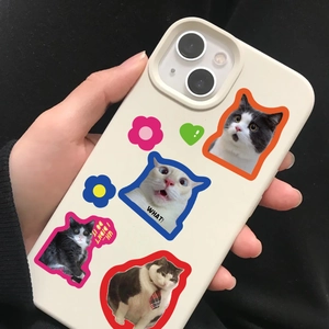 Close-up of beige phone case with cute cat memes and floral decorative patterns
