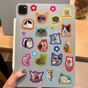 Close-up of cat meme decorative stickers on a tablet back with cute kitten designs