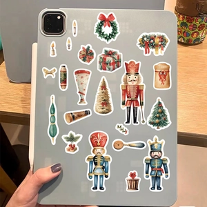 Watercolor Nutcracker Christmas stickers decorating the back of a grey tablet device