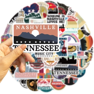Hand holding a Nashville Tennessee vinyl sticker from a 50-piece waterproof decal set