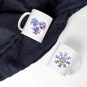 Macro view of two white ceramic mugs with artistic floral and geometric patterns