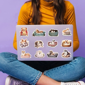 Close-up of cute cartoon cat and dog stickers on a lavender laptop surface