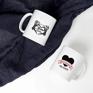 Detail of gothic dark romance stickers on ceramic mugs with skeleton heart and text design