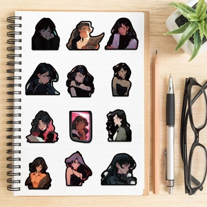 Flat lay of vintage anime girl stickers on a spiral notebook over a rustic wooden desk