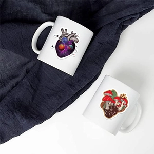 Artistic ceramic mugs featuring heart galaxy and mushroom illustrations on a dark background