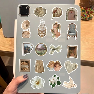 Vintage aesthetic stickers featuring pearls and angels on a tablet case surface