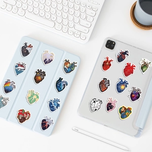 Artistic anatomical heart stickers with Starry Night and ocean wave designs on iPad