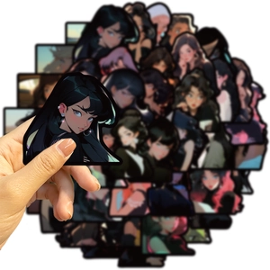 Close-up of a hand holding a vintage anime girl sticker from a 50-piece waterproof DIY set