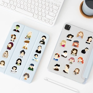 Detailed view of cartoon classic art stickers applied to tablet and transparent case