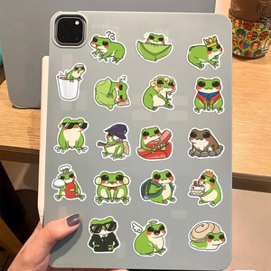 Assorted cartoon frog stickers shown on a tablet back with various cute themes