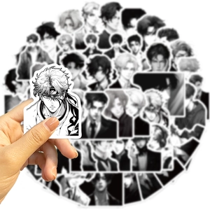 Close-up of waterproof black and white anime boy stickers for laptops and guitars