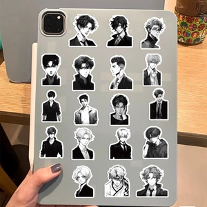 Detail of 19 black and white anime boy stickers applied on a tablet back for DIY decoration
