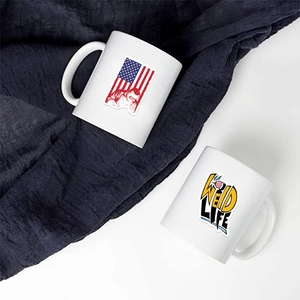 Close-up of waterproof welder stickers featuring American flag and Weld Life on white mugs