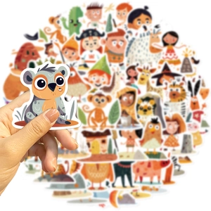 Close-up of hand holding a waterproof cartoon koala sticker for DIY laptop decoration