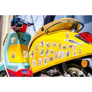 Vintage floral stickers applied on a retro blue and yellow moped for custom decoration