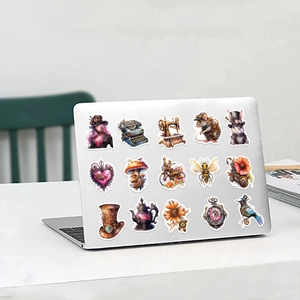 Steampunk stickers displayed on a silver laptop lid featuring retro mechanical designs