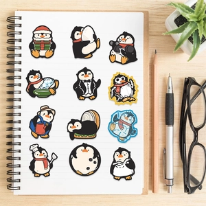 Close-up of cute penguin stickers on a notebook featuring funny cartoon animal designs