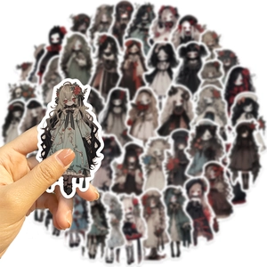 Close-up of a hand holding a gothic anime girl sticker with dark floral details