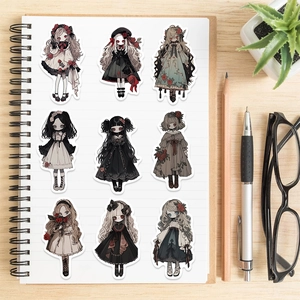 Nine gothic vampire girl stickers arranged on a notebook with artistic stationery