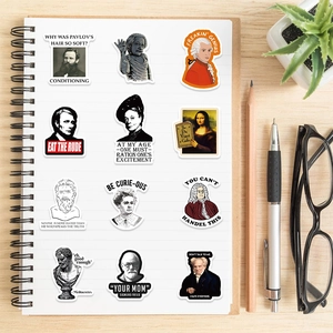Waterproof historic figure stickers on notebook with glasses and pen on wood desk