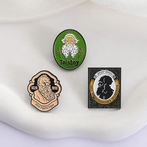 Set of three vintage Leo Tolstoy enamel pins with literary portraits and birth years