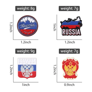 Detail of four Russian flag enamel pins featuring the double-headed eagle and coat of arms