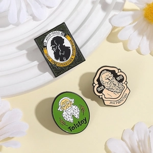Set of three Leo Tolstoy enamel pins featuring iconic portraits and dates on white decor
