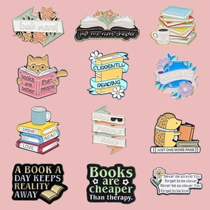 Set of 12 colorful enamel bookworm pins featuring cats, coffee, and reading motifs