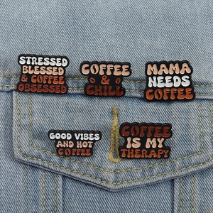 Creative coffee enamel pin set with motivational quotes on denim jacket pocket