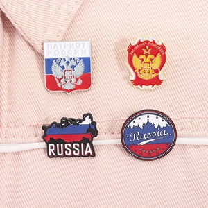 Detail of four Russian flag enamel pins featuring the double-headed eagle and Kremlin silhouette