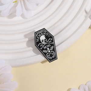 Gothic coffin enamel pin with Memento Mori skull and hourglass on white display stand
