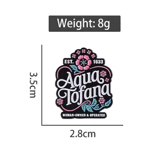 Cartoon enamel pin with floral pattern and Aqua Tofana text, 3.5cm metal badge