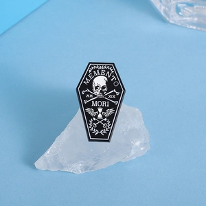 Detail of gothic coffin enamel pin with Memento Mori skull and crossbones design