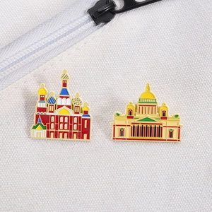Detailed view of Saint Basil's Cathedral enamel pins on white canvas fabric background