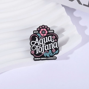 Artistic Aqua Tofana enamel pin with pink cherry blossoms on white display stand