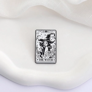 Enamel tarot pin featuring a black cat witch design in a minimalist black and white style