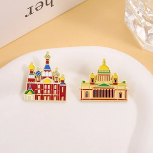 Detailed enamel brooches of Russian Saint Basil's Cathedral on a white texture tray