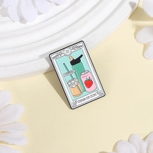 Three of Cups tarot style enamel pin featuring drink containers and strawberry motif