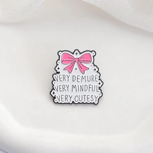 Pink bow metal enamel pin featuring the Very Demure Very Mindful Very Cutesy quote