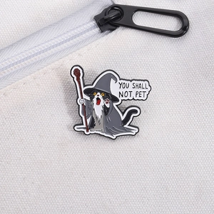 Detail of wizard cat enamel pin on white canvas bag showing You Shall Not Pet text