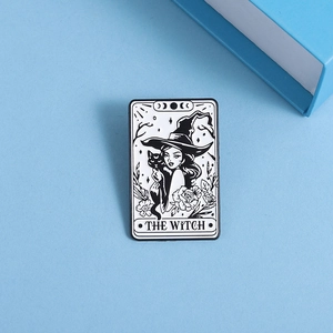 Detail of The Witch tarot card enamel pin with black cat and moon phase design