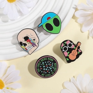 Four-piece enamel pin set with colorful skull, green alien, guitar ghost and quote badge