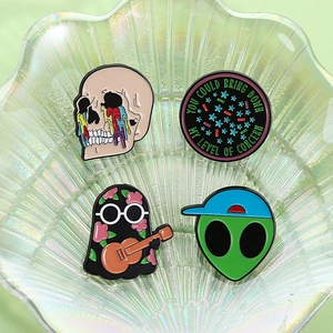 Set of 4 punk enamel pins featuring skull, ghost, and alien designs on a shell plate