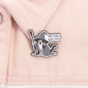 Funny wizard cat enamel pin with You Shall Not Pet quote on pink denim background