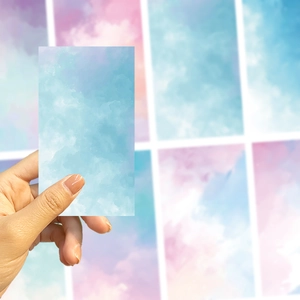 Close-up of watercolor sky blue DIY decorative stickers with gradient cloud patterns
