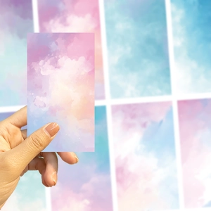 Close-up of decorative DIY phone backing cards with dreamy pink and purple watercolor clouds