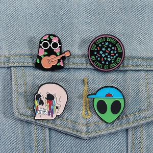 Set of four unique 21 Pilots enamel pins pinned to a light blue denim jacket pocket
