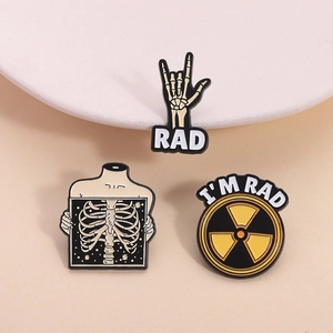 Three creative enamel pins featuring RAD skeleton motifs and medical X-ray graphics