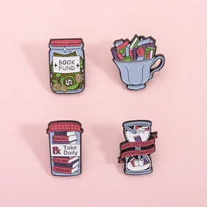 Set of 4 creative enamel book pins including hourglass and book fund bank on pink background