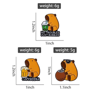 Detailed size chart showing three cute capybara enamel pins with various dimensions